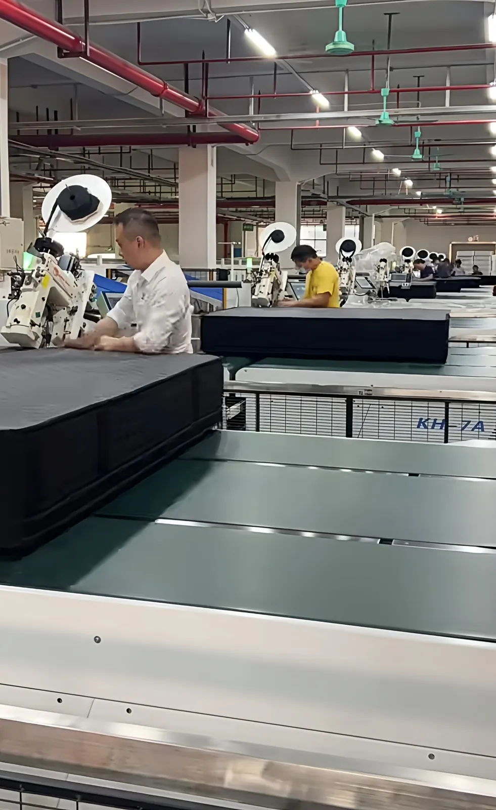 Worker inspecting a mattress on the production line