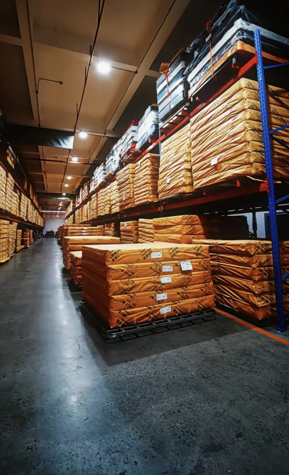 Wrapped mattresses stored on warehouse racks